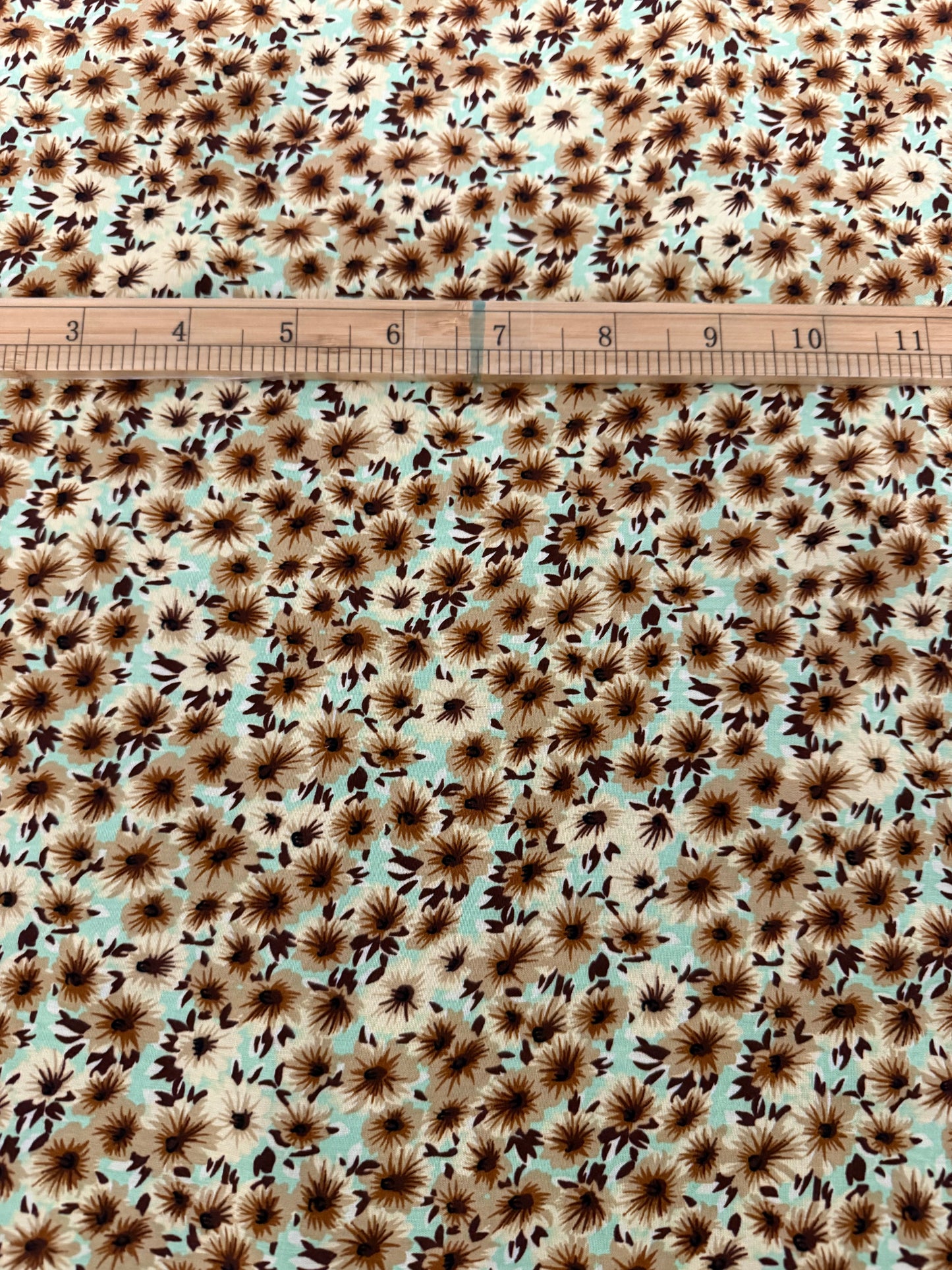 Chocolate Daisy on Mint Viscose Dress Fabric | Sold by the Metre